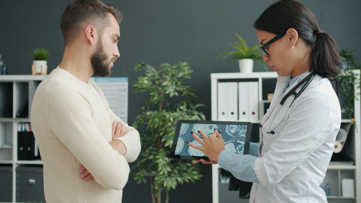 Doctor reviewing information on a tablet with a patient
