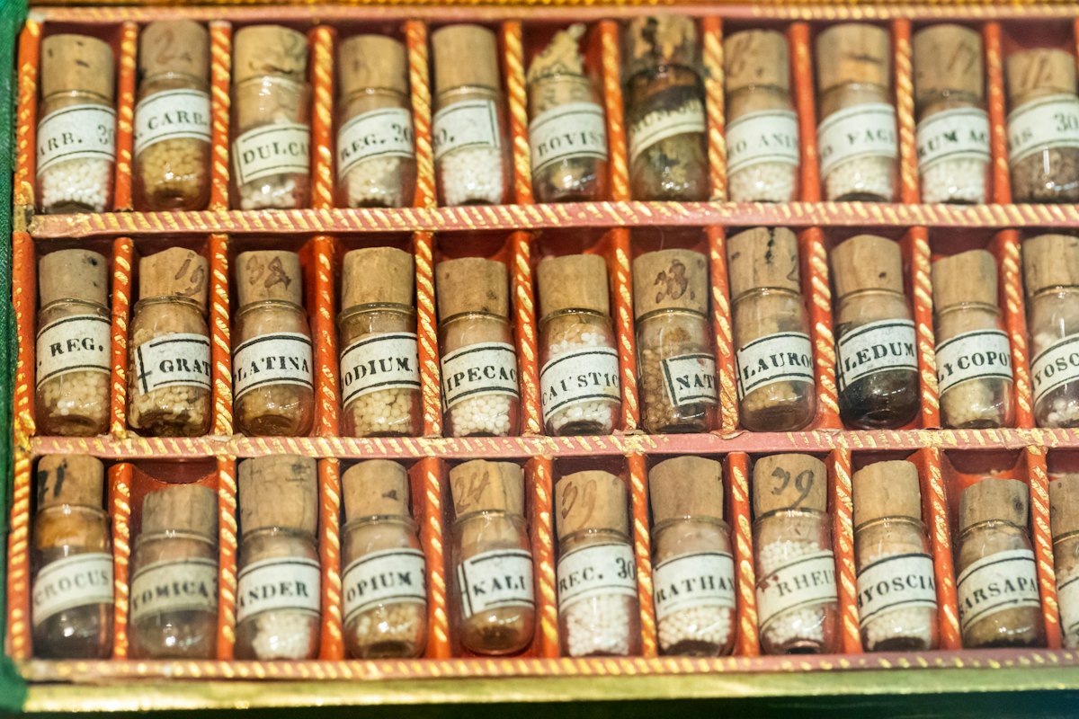 Shelves of small labelled homeopathic remedy vials